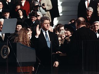 President William (Bill) J. Clinton, , standing between Hillary Rodham Clinton and Chelsea Clinton, taking the oath of office of President of the United States, January 21, 1993. During his administration, the United States enjoyed more peace and economic well-being than at any time in its history. He was the second U.S. president to be impeached and found not guilty.