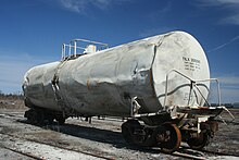 A damaged DOT-111A tank car. Note the AAR Type E double shelf coupler required for transporting dangerous goods. Damaged tank car.jpg