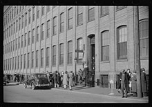 Employees leaving Brown and Sharpe Manufacturing Company, December 1940. Photo by Jack Delano. Delano-Brown-and-Sharpe.jpg