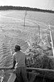 Fisherman laying out seine net - Naples Florida (13957177162).jpg