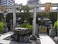 Two small Inari shrine with two foxes guarding each fronts