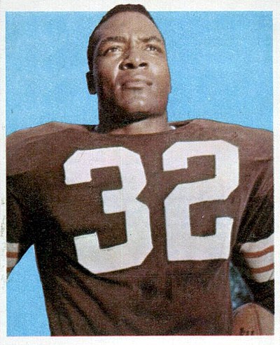 Cleveland running back Jim Brown set a league record with 1,527 yards gained and scored 17 touchdowns in a season culminating with a Most Valuable Player award.