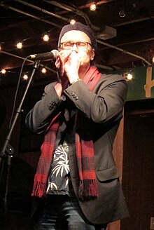 Joe Filisko playing a harmonica live in 2013