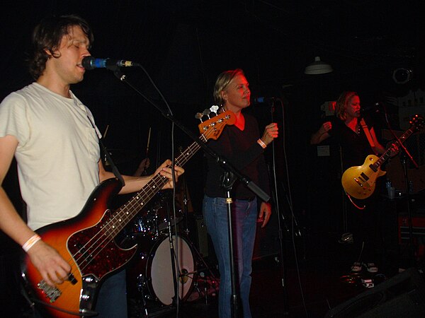 Oh-OK performing in 2007. From left to right: bassist Scott Rowe, drummer Chad Williams (obscured except for his hands), singer Linda Hopper, and guit