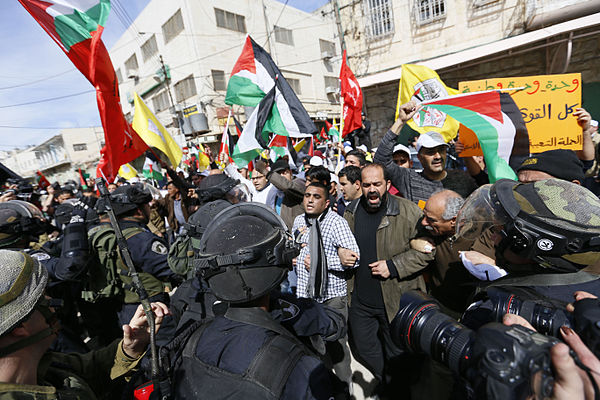 Israeli security forces preventing Palestinians from entering Al-Shuhada Street during a demonstration on the 20th anniversary of the massacre