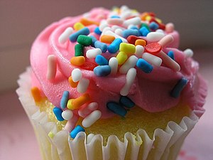 Close-up of cupcake with pink frosting and spr...