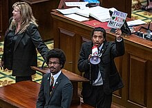 Representatives Justin Jones, Justin J. Pearson, and Gloria Johnson protest for gun reform on the floor of the Tennessee House of Representatives in the wake of the Covenant School shooting in Nashville. Protest-Capitol-048-2048x1464.jpg