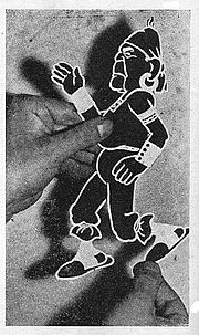 Italian-Argentine cartoonist Quirino Cristiani showing the cut and articulated figure of his satirical character El Peludo (based on President Yrigoyen) patented in 1916 for the realization of his films, including the world's first animated feature film El Apostol. Quirino Cristiani con una figura.jpg