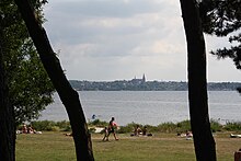 Roskilde Fjord with Roskilde Cathedral in the distance Roskilde Fjord and Cathedral.jpg