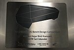 Plaque recognising Siti Nur Hajar Binti Kamsani as designer of the bench for the station. The design was submitted as part of a bench design competition.[5]