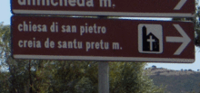 Bilingual sign pointing to a church
