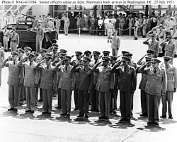 As acting chief of naval operations (fourth from left), saluting the arrival of Admiral Forrest P. Sherman's body at Washington National Airport, July 25, 1951