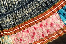 Detail of a Hmong skirt with hemp cloth and batik elements Skirt, Hmong Hoa, Tuyen Quang, view 2, 1976, three sewn panels in hemp, major part in batik, embroidered patterns and applique - Vietnamese Women's Museum - Hanoi, Vietnam - DSC03747.JPG