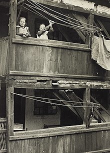 A slum dwelling in Borgergade in central Copenhagen Denmark, about 1940. The Danish government passed The Slum Clearance Act in 1939, demolished many slums including Borgergade, replacing it with modern buildings by the early 1950s. Slum in Borgergade-Aderlsgade.jpg