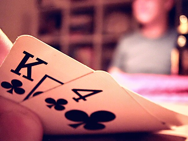 A player examines their cards in a game of Texas hold 'em.