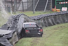 A tyre wall stops a crashing Toyota MR2 Tyre wall impact with water spray - geograph.org.uk - 2435809.jpg