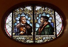 Glass window in the town church of Wiesloch featuring Martin Luther and John Calvin commemorating the 1821 union of Lutheran and Reformed churches in the Grand Duchy of Baden Union luthercalvin.jpg