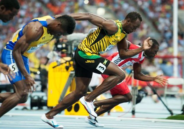 100 m race record holder Usain Bolt (in yellow) and other runners in sportswear.