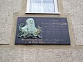 Commemorative plaque on a residential building in closed development