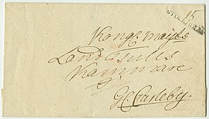 Vanha kirje, jossa on koristeellista tekstiä, postileima ja kartteerausnumero 15.