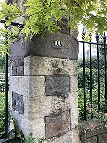A gatepost with the number 100 on it.