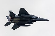 An F-15E Strike Eagle, tail number 91-0302, taking off from RAF Lakenheath in England. The aircraft is assigned to the 492nd Fighter Squadron.