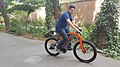 A man riding an electric bicycle.jpg