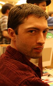 Homestuck creator Andrew Hussie at a fan convention in 2010 Andrew Hussie (with art blurred).jpg