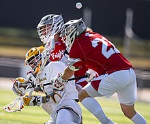 Two Knights men's lacrosse players take down a Baldwin Wallace Yellow Jackets player in 2023 Baldwin Wallace Yellow Jackets Men's Lacrosse (52790162819).jpg