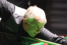 Amateur player Barry Pinches (pictured) replaced David Grace, who withdrew. Pinches defeated the 2020 champion and seventh seed Shaun Murphy 4-3 on the last black. Barry Pinches PHC 2016-3.jpg