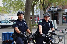 Two police officers on bicycles in Bellingham, Washington Bellingham, WA Police Bicycle Cops (17327642741).jpg