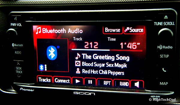 A car audio receiver playing music being streamed via Bluetooth from a smartphone