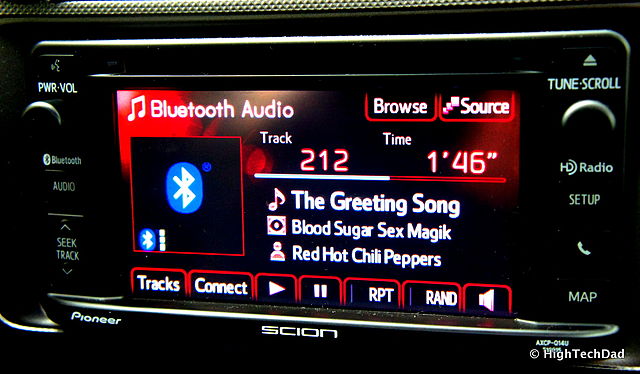 A car audio receiver playing music being streamed via Bluetooth from a smartphone