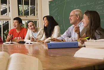 English: A Harkness table being used at the Co...