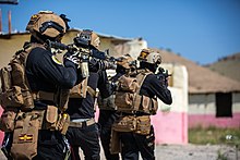 Members of the ISOF force move in a single file around buildings during military training in Mosul, April 5, 2018. Counter-terrorism Training 180405-A-TC961-0110.jpg