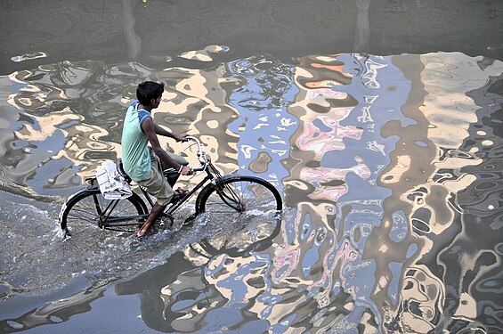 Through the flooded street on a bicycle