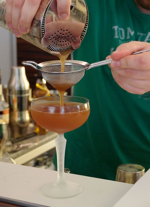 Double straining a cocktail