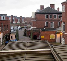 The museum roof in the foreground follows the walls of the Greyfriars Church, covering Richard III's grave site at the far end. The nave of the Church continued west across New Street and some distance into the next car park. Dynasty Death and Discovery, Richard III museum Greyfriars Church site.jpg