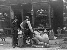 Evicted men and child with belongings on street. New York City, 1910s. East Side Eviction.jpg