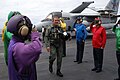 Bush on the USS Abraham Lincoln wearing a flight suit after landing on the aircraft carrier in a military jet.