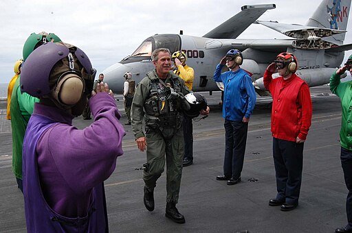 George W Bush on the deck of the USS Abraham Lincoln