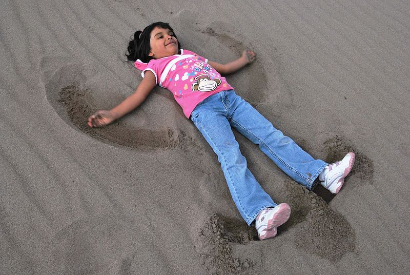 File:Girl Making a Sand Angel (12660998534).jpg