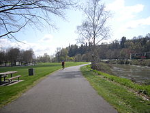 Bicycle approaching on Green River Trail as it passes through Fort Dent Park. This is looking upstream on the right bank of the Green River. Green River Trail in Fort Dent Park 02.jpg