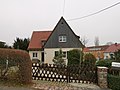 Residential house in a settlement, with enclosure