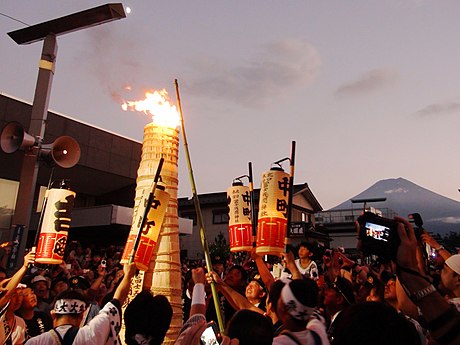 Lighting street torches at the Fujiyoshida, Yamanashi, Fire Festival