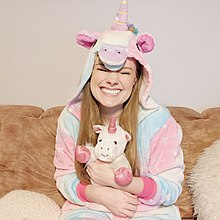 A person wearing a unicorn onesie Jow Rowe Unicorn Onesie.jpg