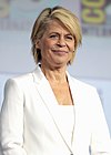 Photo of a woman with short blonde hair in a white suit