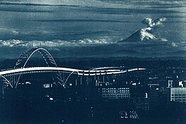 Mount St. Helens erupting on May 18, 1980, with the Fremont Bridge visible in the lower left corner. MSH-10B Mount St. Helens Erupts, Portland View, May 18, 1980 (22636191326).jpg