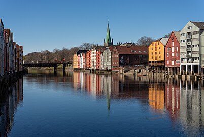 Nidelva river with old storehouses on both shores and the Old Town bridge in the background, Trondheim, Norway