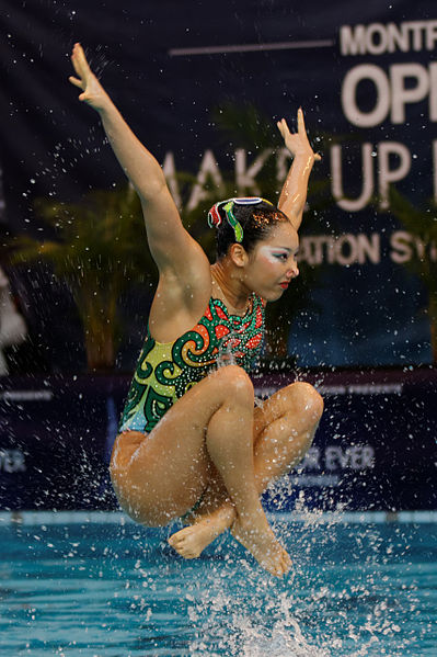 A member of the Japanese team is thrown up in the air by other members under the water during the team's free routine at the 2013 French Open.